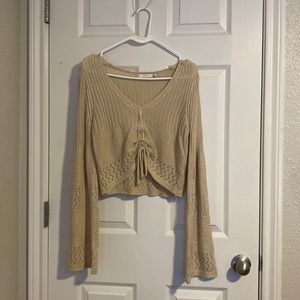Large lush shirt. Color beige. See through. Scrunches into a crop top like shirt